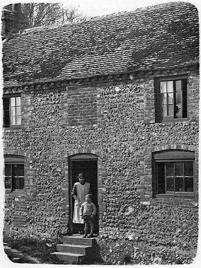 Mum and meat our cottage in Piddinghoe, Sussex, about 1925